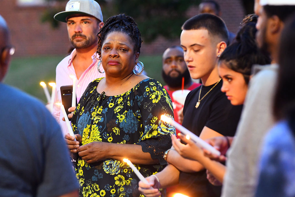 Cheryl Wright listens to a speaker at a vigil for her granddaughter, Nadria Wright